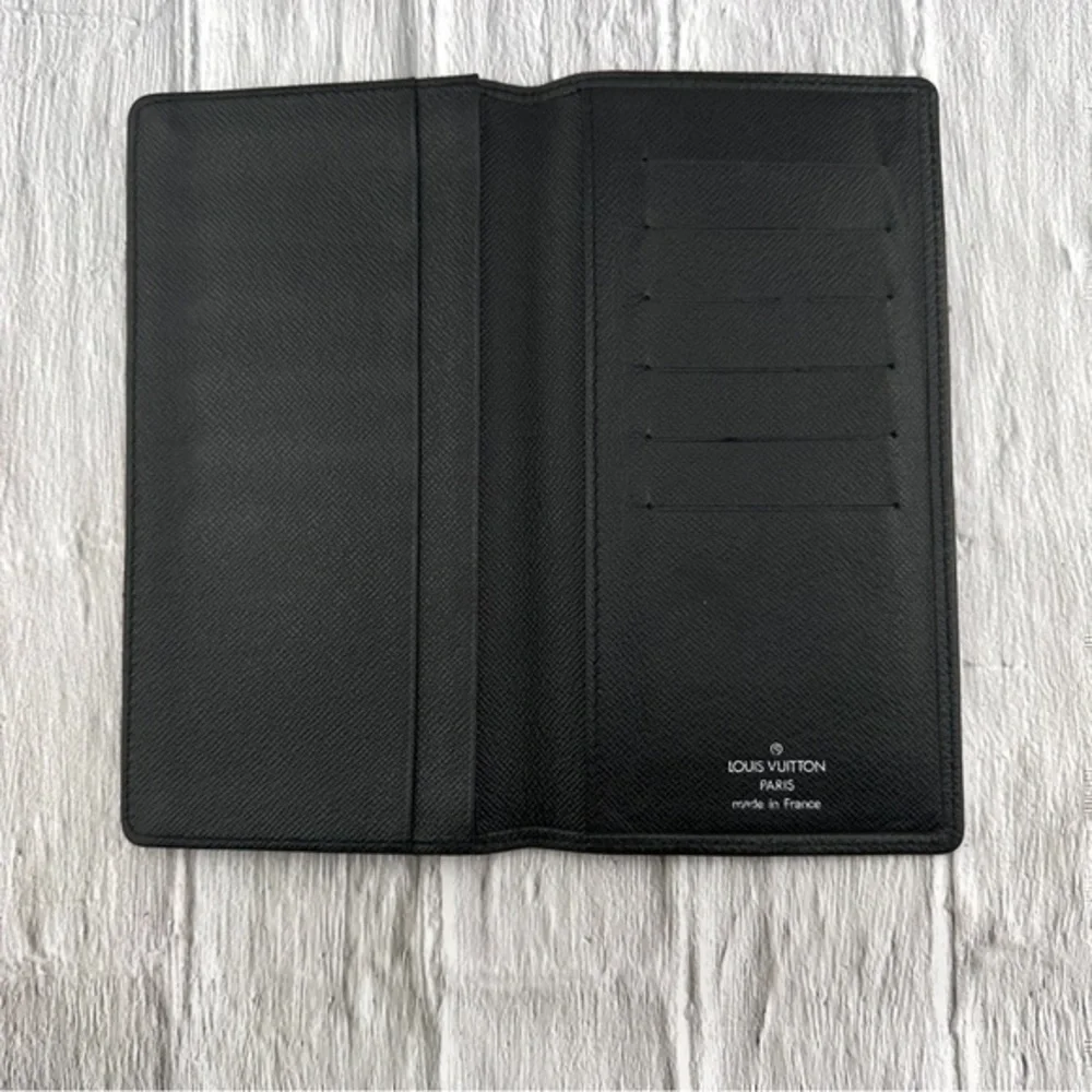 AUTHENTIC Louis Vuitton Taiga wallet. Previously owned. Color: Black.